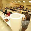 Katie Teague, Washington County Extension agent, bottom, demostrates the construction of a rain barr...