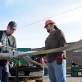 Eric Winnett, right, watches as Taylor Tompkins, both of Willow Creek Renewable Energy, tightens bol...