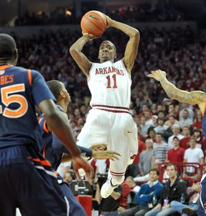 Arkansas Democrat-Gazette/MICHAEL WOODS --01/25/2012-- University of Arkansas guard BJ Young pulls up for a jump shot over Auburn defenders on a fast break during the first half of Wednesday evening's game at Bud Walton Arena in Fayetteville.