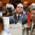 Rogers Mayor Greg Hines listens as Kathy Deck delivers her economic and jobs forecast for Northwest ...