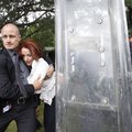 Prime Minister Julia Gillard is escorted out for safety by body guards and police through a crowd of...