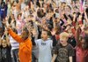 Brylan Sims, Marc Franklin and Joshua Harris, Asbell Elementary School kindergarten students, from left, celebrate Wednesday while singing the school song during an assembly to announce a $100,000 donation from Target after a nomination by a parent through The Ellen DeGeneres Show.