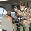 Park Rangers Ryan King, left, and Alan Bland count and photograph bald eagles at Beaver Lake on Jan....
