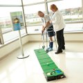 The Joint Replacement Center’s program coordinator, Karen Tanner, helps a patient play golf, which i...
