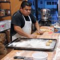 Oscar Campos prepares donuts Wednesday at Ayala’s Family Bakery.