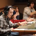 Daniel Masse, a senior at Fayetteville High School, speaks into a headset while changing cameras Thu...