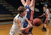 Alex Rice, left, a Springdale Har-Ber junior, passes around Rogers Heritage senior Blake Woodson (55) in the first half Friday in Wildcat Arena in Springdale.
