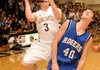 Austin Haggard, Bentonville guard, left, shoots for two points over Rogers Guard Josh Anderson at Tiger Arena in Bentonville on Friday.
