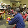 LION DANCE The lion follows and fights its handler Charlie Wishon, right, in a traditional Chinese L...
