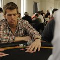 HELPFUL HAND Zach Burks with Saatchi & Saatchi X in Springdale reaches for his cards Saturday during...