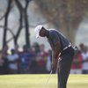 Woods fires 66, shares lead with Rock