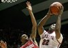 Alabama’s Andrew Steele (22) goes around Arkansas’ Ky Madden (00) for a first-half shot in the Crimson Tide’s 72-66 victory Saturday at Coleman Coliseum in Tuscaloosa, Ala. Steele came off the bench to score 11 points and grab six rebounds. 
