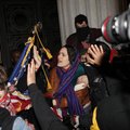 A woman pleads with Occupy Oakland protestors to not burn an American flag found inside Oakland City...