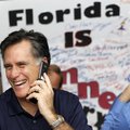 Republican presidential candidate, former Massachusetts Gov., Mitt Romney laughs as he speaks with a...