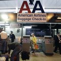 American Airlines baggage handlers help passengers check luggage at Dallas-Fort Worth International ...