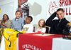 STAFF PHOTO ANTHONY REYES -- Springdale High football players Tony Dennis, right, and Kempys Robinson, second from left, smile before signing national letters of intent Wednesday Feb. 1, 2012 in Bulldog Fieldhouse in Springdale. Joining them at the table are, from left, Diann Robinson, Kamond Robinson, 11, and Dennis' sister Isabella Cates, 8. Dennis signed with Arkansas Tech University, while Robinson signed with the University of Arkansas at Pine Bluff.