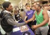 STAFF PHOTO ANDY SHUPE -- Fayetteville senior Casey Perry, left, is congratulated Wednesday, Feb. 1, 2012, by teammate Chris Humphrey, right, and the rest of the Bulldog football team after Perry signed a letter of intent to play football for Evangel University in Springfield, Mo., during a signing ceremony at Fayetteville's field house.
