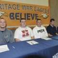 STAFF PHOTO FLIP PUTTHOFF -- Rogers Heritage High School football players Jonathan James, from left,...
