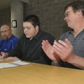 STAFF PHOTO FLIP PUTTHOFF -- Rogers Mounties offensive lineman Thomas Jespersen signs his Missouri S...