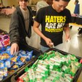 John LaRue, left, and Gerardo Rueda, both 17 and students at Rogers Heritage High School, help bundl...