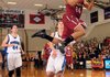 Chasen Williamson, Springdale High, right, takes the ball to the basket in front of Rogers High’s Josh Anderson during the game Tuesday at Rogers High School.