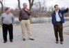 On the trail around Lake Springdale, Alan Pugh, chief engineering coordinator for Springdale, right, discusses construction plans Tuesday to connect Lake Springdale to the Razorback Greenway with, from left, Ron Duncan, commissioner of the Arkansas Game & Fish Commission, and Doug Sprouse, Springdale mayor. The grant is one of 13 awards for trail programs throughout Arkansas and the largest of three awards given for projects in Northwest Arkansas. Springdale Rotary Club members and Boy Scouts will begin clearing the area Saturday to prepare for the project which will include an observation deck and trail next to the lake.