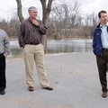 On the trail around Lake Springdale, Alan Pugh, chief engineering coordinator for Springdale, right,...