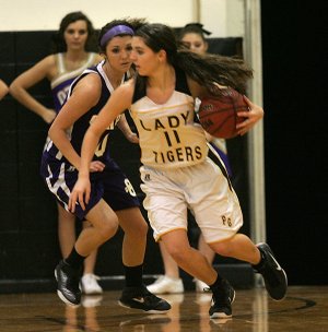 Abby Smith, Prairie Grove sophomore, drives to the basket Tuesday against Ozark during the first half in Prairie Grove.