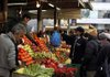 Shoppers look at produce Friday at an outdoor market in Athens, Greece. Negotiations between the Greek government and unions and employers’ associations slowed Friday, delaying progress toward new bailout deals. 