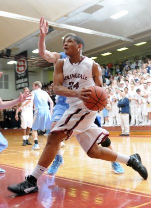 Springdale High’s Chasen Williamson drives toward the hoop Friday during the second quarter of the game against Springdale Har-Ber at Bulldog Arena in Springdale.
