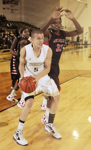 Nick Smith, Bentonville High, goes up for a shot against Fort Smith Northside defender Deontae Woodbridge on Friday in Bentonville.
