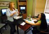 Lacy Maybee, left, a child advocate and forensic interviewer, meets Friday with Shanna Robertson, a family service worker and investigator for the Department of Human Services, before an interview for a child-abuse case at the Children’s Advocacy Center of Benton County in Little Flock.
