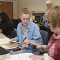 A TAXING SEASON Jannie Riley, volunteer income tax aide, left, helps Sheila Maestri of Bentonville f...