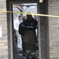 Firefighters and police investigate the fire scene on Friday at 434 McCann Road in Rogers.
