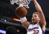 Los Angeles Clippers forward Blake Griffin, right, dunks as Oklahoma City Thunder guard Reggie Jackson looks on during the first half of an NBA basketball game in Los Angeles, Monday, Jan. 30, 2012. (AP Photo/Chris Carlson)