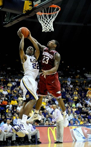 LSU's Ralston Turner,left, shoots against Arkansas' Julysses Nobles during an NCAA college basketball game, Saturday, Feb. 4, 2012 at Pete Maravich Assembly Center on the LSU campus in Baton Rouge, La.  (AP Photo/The Advocate, Libby Isenhower) MAGS OUT, INTERNET OUT, NO SALES, TV OUT, FOREIGN OUT, LOUISIANA BUSINESS INC./GREATER BATON ROUGE BUSINESS REPORT/225/10/12/IN REGISTER/LBI CUSTOM PUBLICATIONS OUT 