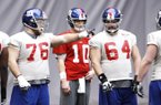 Former Arkansas linemen Tony Ugoh (70) and Mitch Petrus (62) work with other New York Giants linemen and quarterback Eli Manning during practice Friday. Ugoh and Petrus expect to see playing time today when the Giants meet the New England Patriots in the Super Bowl. 