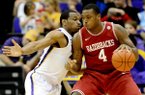 Arkansas forward Devonta Abron (4) works the ball against LSU’s Storm Warren during Saturday’s game at Pete Maravich Assembly Center in Baton Rouge. 