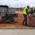 Mike Pope, right, and William Skidmore of CDI Contrators move concrete blocks onto a vehicle Tuesday...