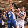 Wayne Henry, Rogers senior forward, takes a shot as Fayetteville junior post Tyler McCullough, right...