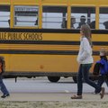 Students at Centerton Gamble Elementary School go to their bus Friday. The Bentonville School Board ...