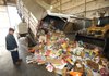 Tony Diaz, a route driver for the city of Fayetteville’s Solid Waste and Recycling Division, helps to unload cardboard Thursday at the city’s transfer station.
