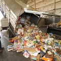 Tony Diaz, a route driver for the city of Fayetteville’s Solid Waste and Recycling Division, helps t...