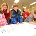 Peyton Denham, a first-grader at Bob Folsom Elementary School, left, gets some help from teacher Nic...