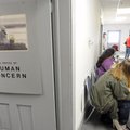 Residents wait their turn to meet with a clerk early Wednesday during their first day of the Low Inc...