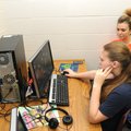 Brittany Wilcutt, background, watches as Arielle Williams works on a virtual reality tour of a class...