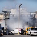 Smoke billows out of an area where firefighters are working to control and ammonia leak, Monday Feb....