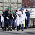 A plant worker at Cargill Turkey Plant on Randall Wobbe Lane, Monday Feb. 6, 2012, is escorted out o...