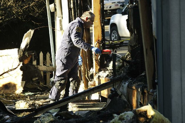 a-pierce-county-fire-investigator-examines-debris-monday-feb-6-2012-at-the-home-where-josh-powell-and-his-two-sons-were-killed-sunday-in-graham-wash-powells-wife-susan-went-mysteriously-missing-from-their-west-valley-city-utah-home-in-december-2009-ap-phototed-s-warren