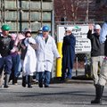 A plant worker at Cargill Turkey Plant on Randall Wobbe Lane is escorted out of the plant Monday aft...